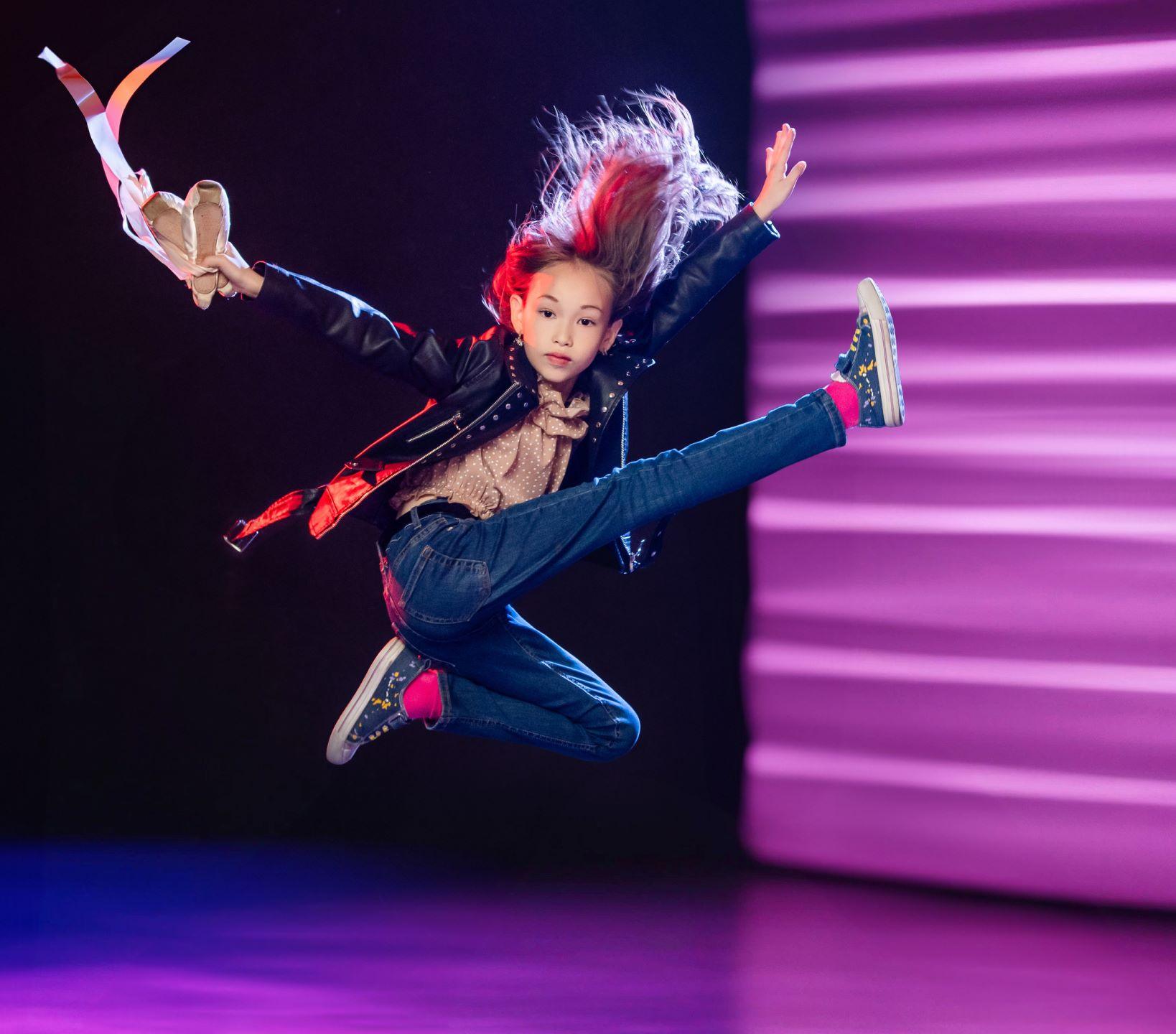 A girl on stage dancing and jumping